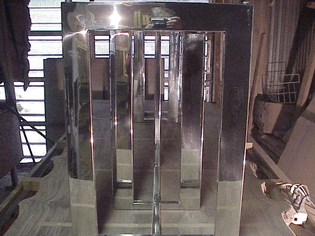 Stainless steel legs being fitted to table top .