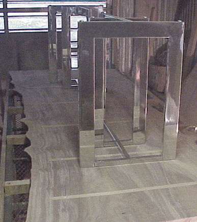 Shop photo - Claro slab dining table with stainless legs being fitted.