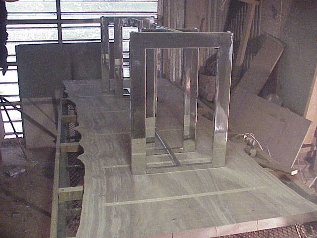 Shop photo - Claro slab dining table with stainless legs being fitted.