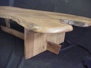 Slab table of solid White Oak. Live natural edged top. Sharp corner traditional legs.