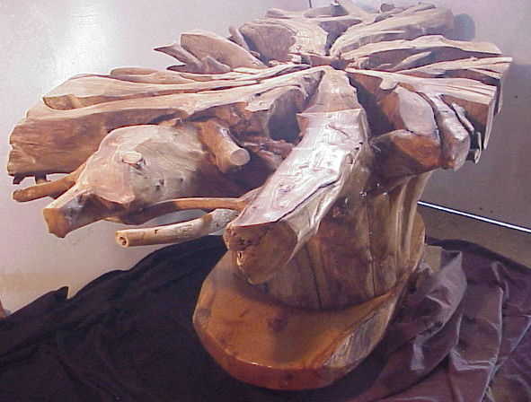 Inverted root stump table. Will receive an oval glass top 8 ft. by 4 ft. 